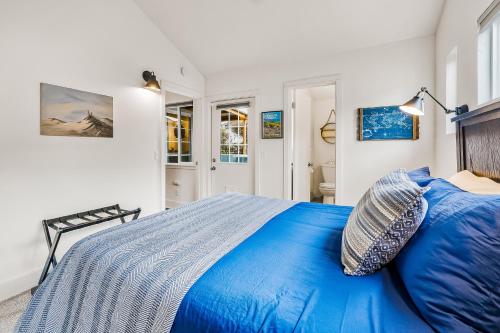 a bedroom with a blue bed with a blue pillow at Jewel by the Sea in Cambria