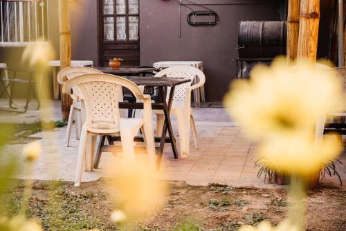 a table and chairs sitting in a patio with flowers at Hostal Namaste in Salta