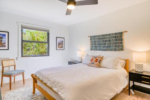 a bedroom with a bed and a desk and a window at Casita Colibri in Santa Fe
