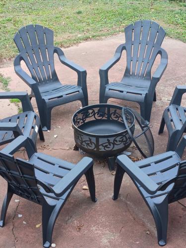 a group of four chairs and a fire pit at Birmingham's Spacious Uptown Family Retreat in Birmingham