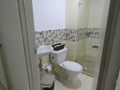 a bathroom with a toilet and a sink at La Tebaida Quindío Reserva de la Colina E104 in La Tebaida