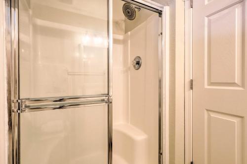 a shower with a glass door in a bathroom at 3 Mi to Bethany Beach Gem with Deck and Pool Access in Ocean View