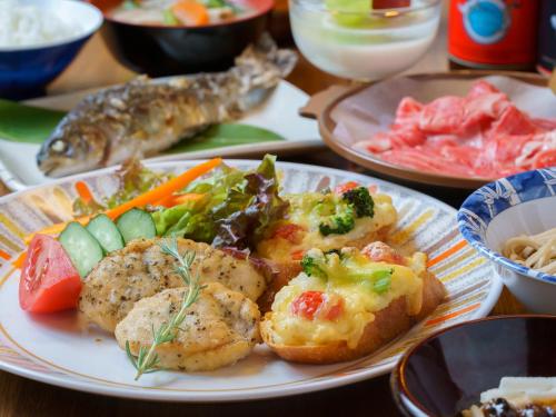 a plate of food on a table with food at Villa Alpen in Yamanouchi