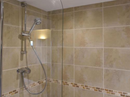 a shower with a shower head in a bathroom at Uk39799 - Old Corner Barn in Troutbeck