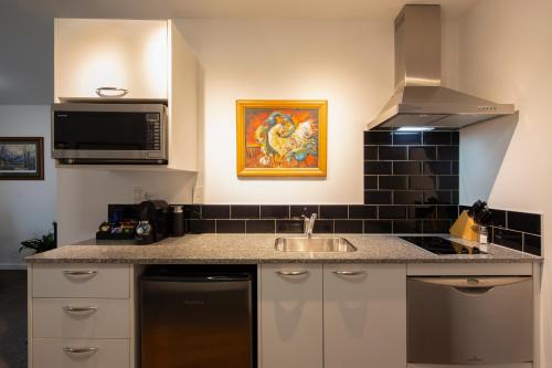 a kitchen with a sink and a microwave at The Glebe Apartments in Queenstown
