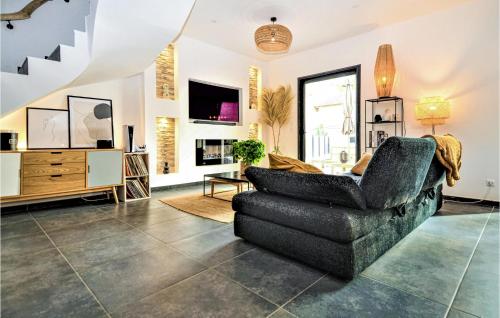 a living room with a couch and a chair at 3 Bedroom Amazing Home In Montfavet in Montfavet