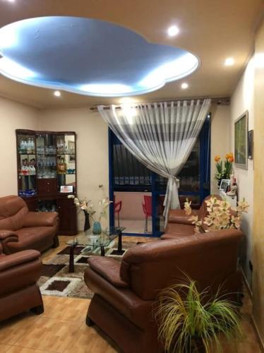 a living room with couches and a blue ceiling at Deluxe & Big Appartment City center in Fier