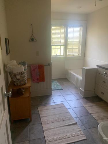 a bathroom with a tub and a sink at Happy Ass Farm in Fort Scott