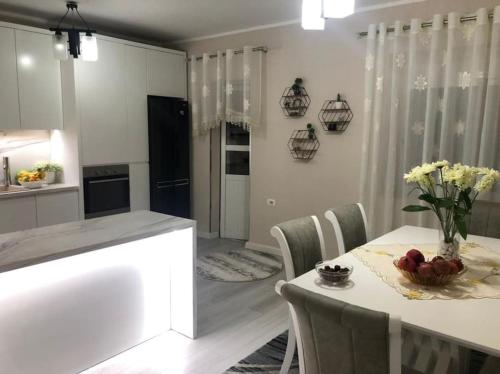 a kitchen with a table with a bowl of fruit on it at Luxury appartment Citty center in Fier