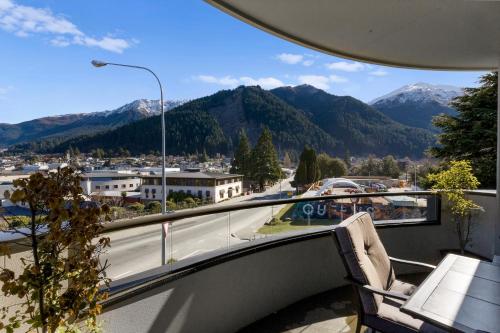 a balcony with a view of a city and mountains at The Glebe Apartments in Queenstown