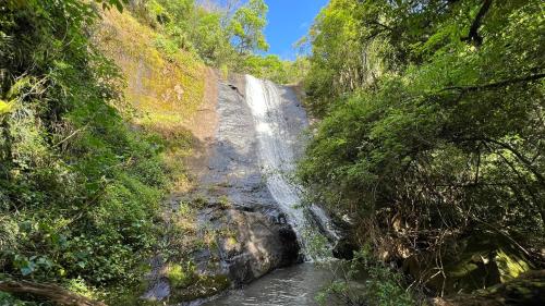 a waterfall in the middle of a river at Chalés da Cascata - Pitanga in Gramado