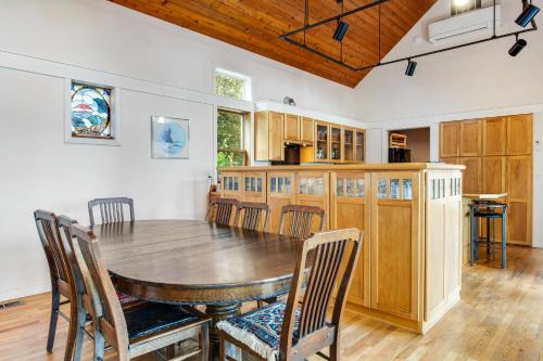 a large kitchen with a wooden table and chairs at The American Dream in Lakewood
