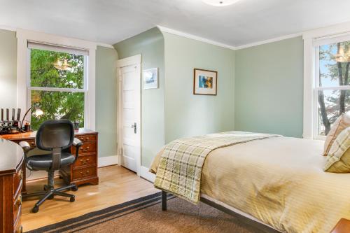 a bedroom with a bed and a desk and a chair at The American Dream in Lakewood