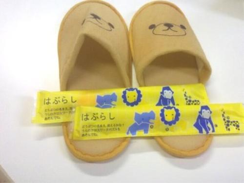 a pair of shoes with a yellow bow tie at HOTEL GLAN Y's KUMAGAYAEKIMAE premier in Kumagaya