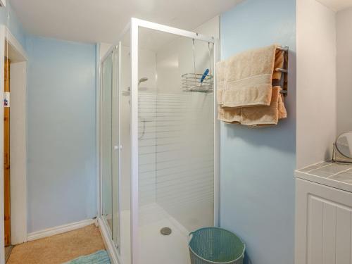 a shower with a glass door in a bathroom at Seaside in Ventnor