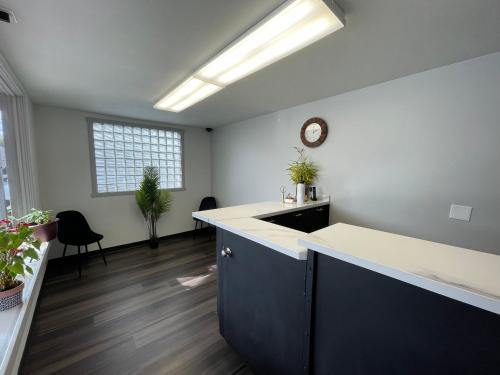 an office with a desk and a clock on the wall at Holiday Motel in Portland