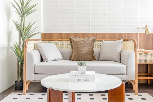 a living room with a couch and a coffee table at Choco Style Inn in Taitung City