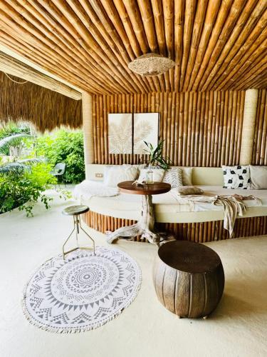 a living room with a couch and a table at The Beach House Ocam Ocam in Busuanga