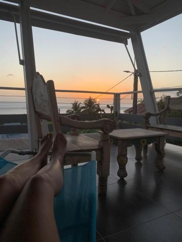 a person laying on a chair watching the sunset at Villa Lanar'am in Bouillante