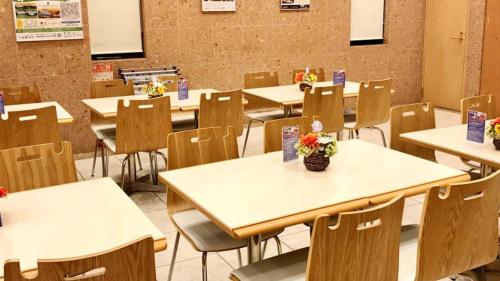 an empty classroom with tables and chairs with flowers on them at Toyoko Inn Osaka Shinsaibashi Nishi in Osaka