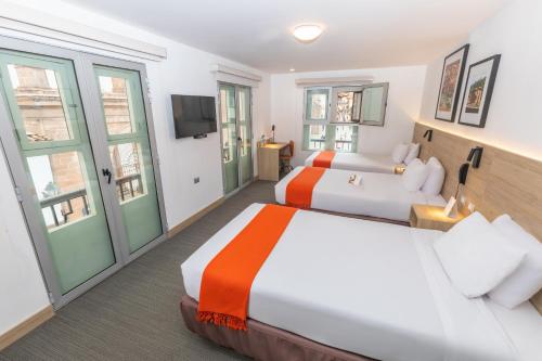 a hotel room with two beds and a tv at Casa Andina Standard Cusco Plaza in Cusco