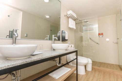 a bathroom with a sink and a toilet and a mirror at Casa Andina Standard Cusco Plaza in Cusco