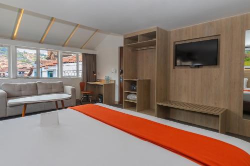 a hotel room with a bed and a television at Casa Andina Standard Cusco Plaza in Cusco