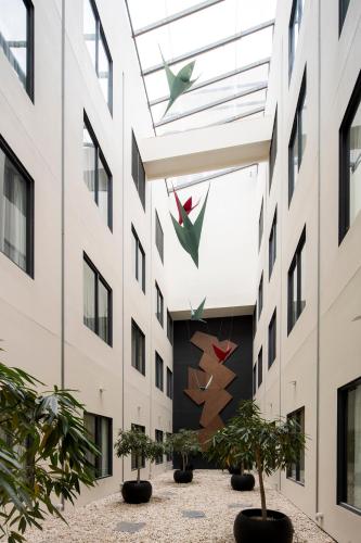 a building with potted plants in a courtyard at The Sebel Sydney Martin Place in Sydney