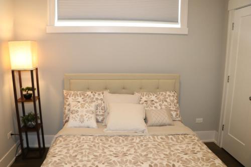 a bedroom with a bed with pillows and a window at Chicago Exquisite Haven 2bed 2bath Near Downtown and United Center in Chicago