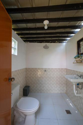 a bathroom with a toilet and a sink at Mountain lake Island Cabin Sierra - for family Getaway in Cavinti