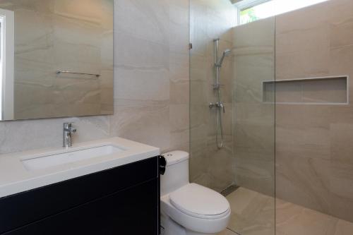 a bathroom with a toilet and a sink and a shower at Orchid Paradise Homes OPV428 in Hua Hin