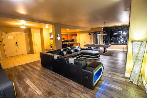 a living room with couches and a ping pong table at 2100 SqFt Penthouse Suite W/ Strip Views! POOL GYM in Las Vegas