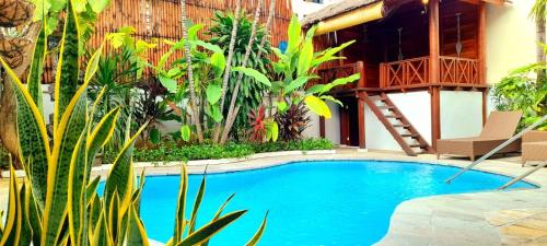 a swimming pool in front of a house at Villa Cantik Kuta Regency in Kuta