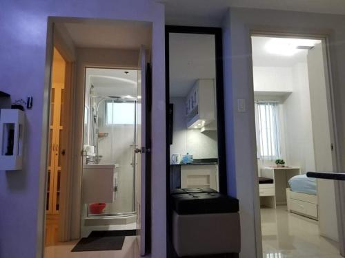 a view of a room with a bathroom and a bedroom at Sea Residences Homey Condo by DNJ in Manila