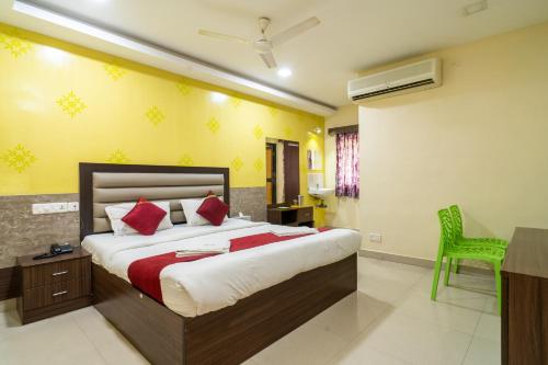 a bedroom with a bed and a desk and a chair at Safa Residency in Tiruchchirāppalli