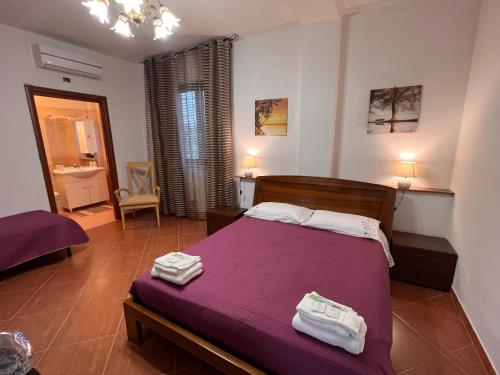 a bedroom with a bed with towels on it at B&B Il tramonto in Barbarano Romano