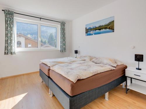 a bedroom with a bed and a large window at Holiday home in Niedernsill near ski area in Niedernsill