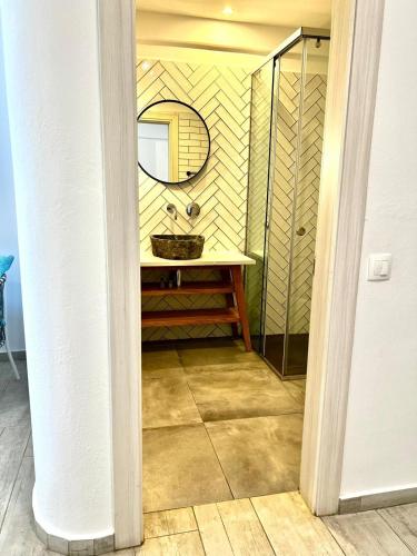 a bathroom with a sink and a mirror at Blue Bay Lifestyle - ex Bali Blue Bay in Balíon