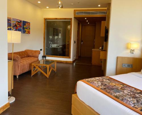 a bedroom with a bed and a living room at Rosetum Kasauli in Kasauli