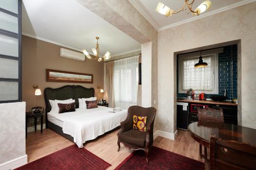 a bedroom with a bed and a table and a chair at Faik Pasha Hotels Special Category Beyoglu Istanbul in Istanbul
