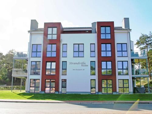 a building with a sign on the side of it at Strandvilla Baabe - Maisonette "Sonnenwiege" mit Sauna und Whirlpool in Baabe