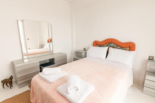 a bedroom with a large bed with a mirror at Vista de Montana Meteora II in Vlacháva