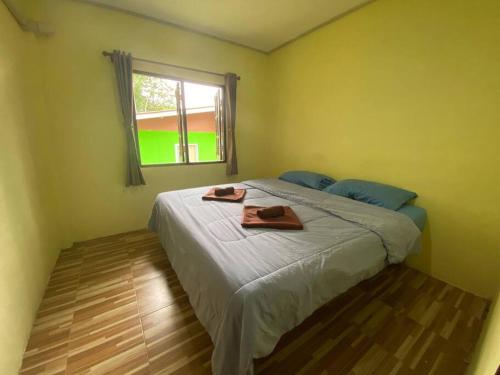 a bedroom with a bed with two towels on it at 2 Bed Sunset Seaview Good View House Y in Ko Yao Noi