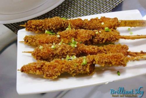 a plate of fried food with chopsticks on a table at Brilliant Sky in Tagaytay