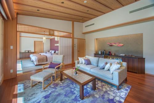 a living room with a couch and a bedroom at ABBA Resorts Izu - Zagyosoh in Ito