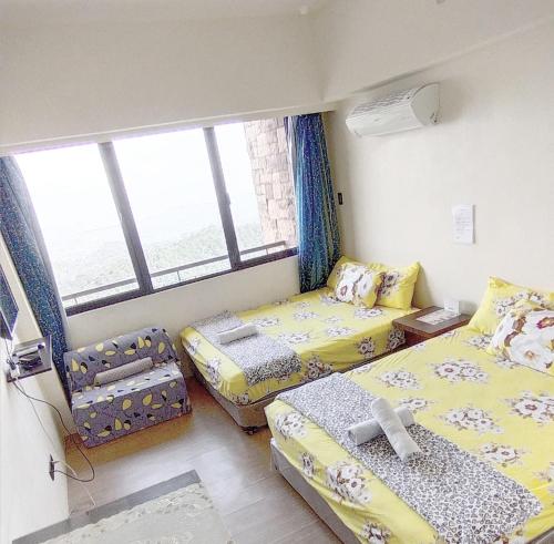 a small room with two beds and a window at Splendido Tagaytay Taal Lake Staycation Free Parking Netflix No Free Pool in Tagaytay