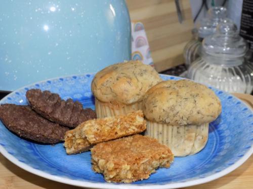a blue plate with cookies and biscuits on a table at Phumla@Lu's in Johannesburg