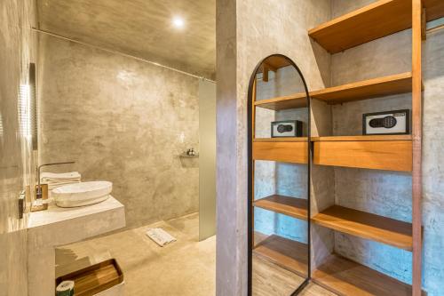 a bathroom with a shower and a toilet and a sink at Leafy Home Canggu in Canggu