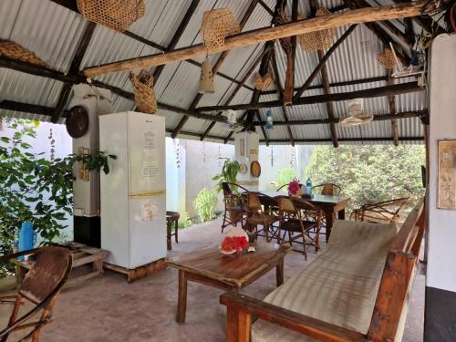 a kitchen and dining room with a table and chairs at Mwana House in Nungwi