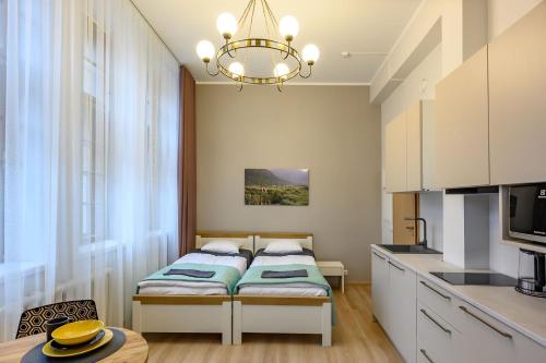 a small bedroom with a bed and a kitchen at Kastanimaja Apartments in Tartu